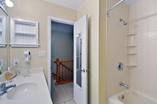 a bathroom with a sink and a tub and a shower at Villa 131 in Jekyll Island