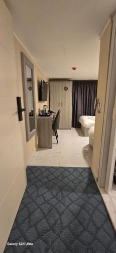 a room with a bed and a desk in a room at VIP Hotel Amman in Amman