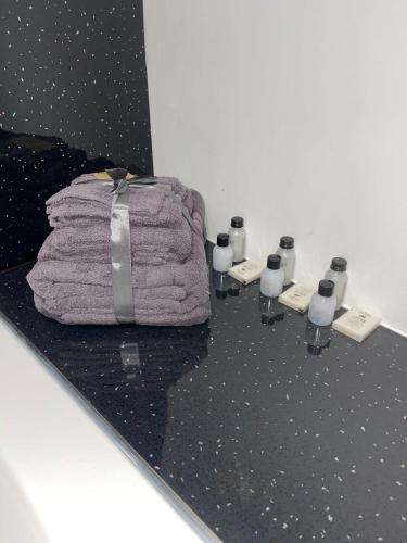 a pile of towels and candles on a table at The Lucia Apartments I - 2 Bedroom Town Centre Apartment - Contractor Friendly - Free Parking - Full Kitchen - Washer Dryer - Spacious - Ideal for Work Stays in Huntingdon