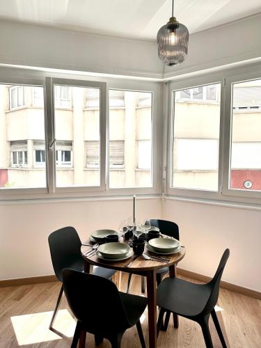 une salle à manger avec une table, des chaises et des fenêtres dans l'établissement Urban Oasis Paris, à Paris
