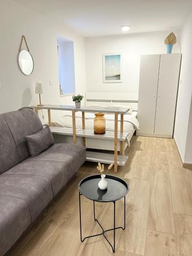 a living room with a couch and a table at Casa Orange in Koper