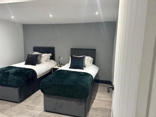 two beds sitting in a room with at The Lucia Apartments II - 1 Bedroom Town Centre Apartment - Contractor Friendly - Free Parking - Full Kitchen - Washer Dryer - Spacious - Ideal for Work Stays in Huntingdon