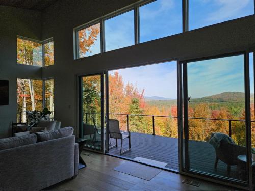 a living room with large windows and a view of the mountains at 1AB Retreat at Arrowhead in Bethlehem