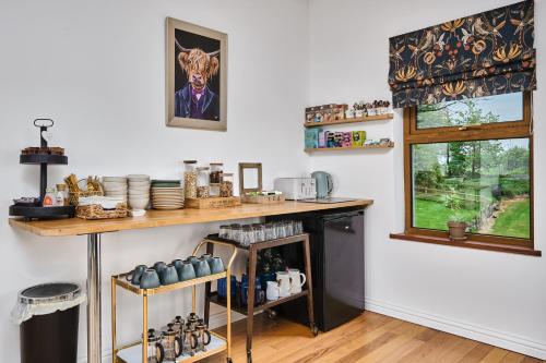 a kitchen with a counter and a window at Carnbore House BnB in Bushmills