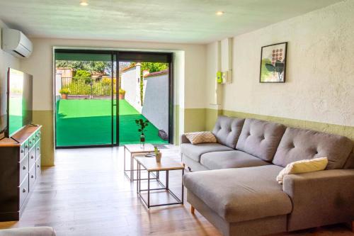 a living room with a couch and a table at Villa du Soleil by Villa Plus in Laroque-des-Albères