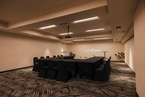 a conference room with a long table and chairs at Hotel Cabo De Hornos in Punta Arenas