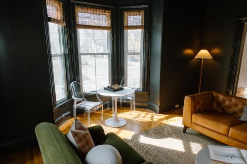 a living room with a couch and a table at The Ipswich Inn in Ipswich