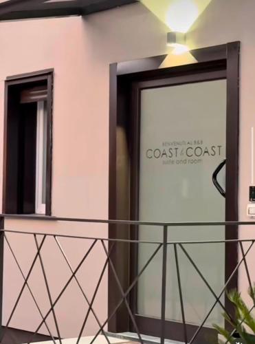 a mirror on the side of a building with a coast coast sign at Coast To Coast - Rooms & Pool! Camere moderne e piscina in Sant'Egidio del Monte Albino