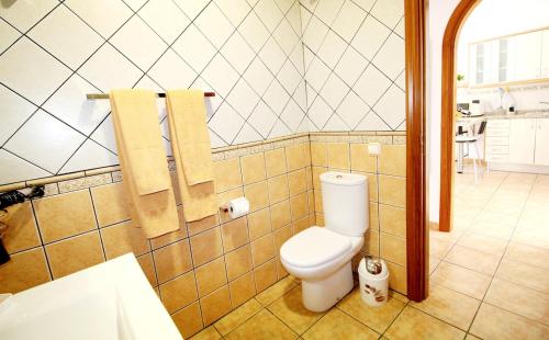a bathroom with a white toilet in a room at Las Cascadas Puerto de Mogán II in Puerto de Mogán