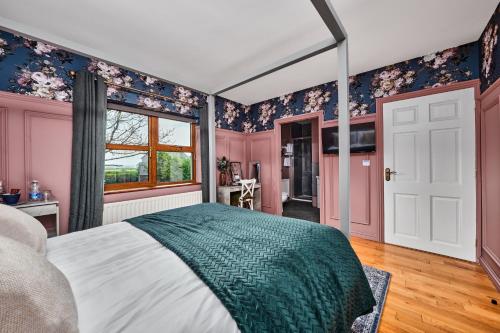a bedroom with pink and blue walls and a bed at Carnbore House BnB in Bushmills