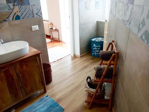 a bathroom with a sink and a mirror and a toilet at Residenza il Rododendro in Candelo