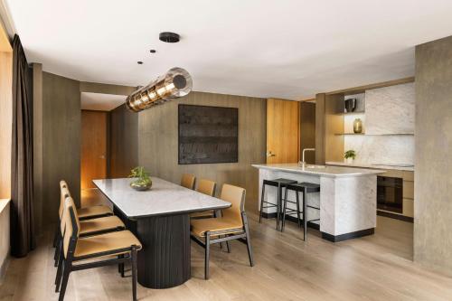 a kitchen with a table and chairs and a counter at JW Marriott Auckland in Auckland