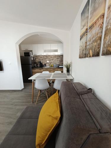 a bedroom with a bed and a table with chairs at Sayohat Apartments in Dobra Voda