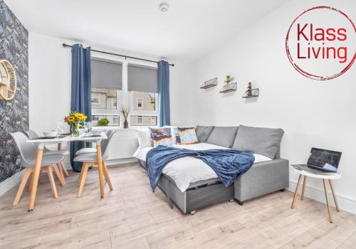 a living room with a bed and a table at Sanderson Apartment by Klass Living Uddingston in Uddingston