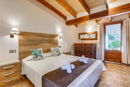 a bedroom with a large bed with towels on it at Villa Vinya Maria by Villa Plus in El Port