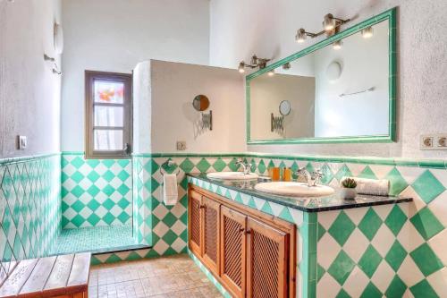 a bathroom with two sinks and a mirror at Villa Vinya Maria by Villa Plus in El Port