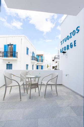 a group of chairs and tables on a balcony at George Studios in Naxos Chora