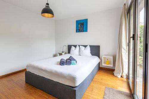 a bedroom with a large white bed with two shoes on it at Feel like home, close to Verzasca, Tenero, Locarno in Gordola