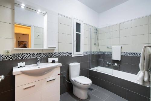 a bathroom with a toilet and a sink and a shower at Villa Olga Katouna by Villa Plus in Katouna