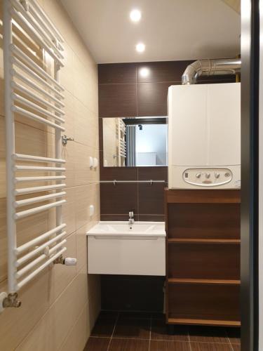a small bathroom with a sink and a mirror at Domek Nadmorski przy plaży Ustka in Ustka