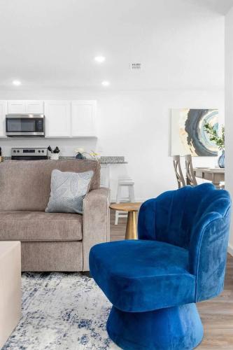 a living room with a blue chair and a couch at Springhill Retreat! 3 bed, 2 Bath! in Spring Hill