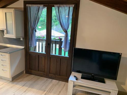 a living room with a flat screen tv next to a door at Argonz Etxea in Urzainqui