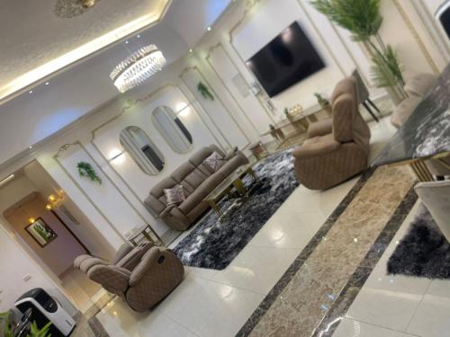 an aerial view of a living room with couches and a television at modern villa with coverable pool sheik zayed in Sheikh Zayed