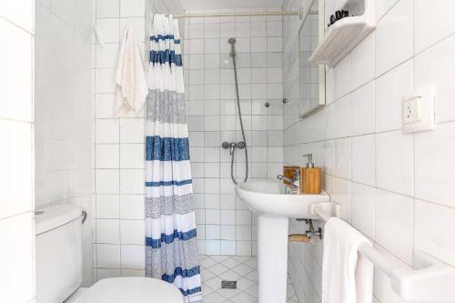 a white bathroom with a sink and a toilet at Villa Oliver by Villa Plus in El Port