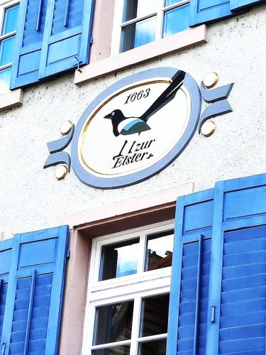 a clock on the side of a building with blue windows at Waldshut -Kaiser55 in Waldshut-Tiengen