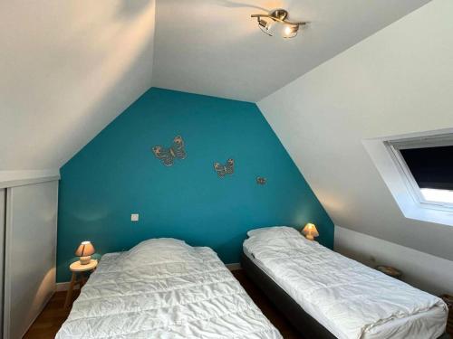 - une chambre avec 2 lits ornés de papillons dans l'établissement Résidence L27-ile Grande - Petit paradis devant la mer à Ile Grande MAE-1943, à Pleumeur-Bodou