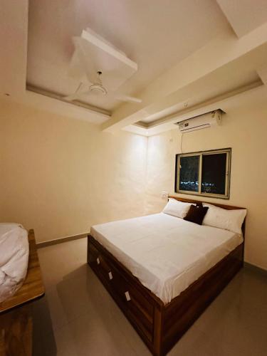 a bedroom with a large bed and a window at Hotel Nx Surya in Chakan