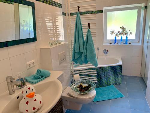 a bathroom with a toilet and a tub and a sink at Schwalbennest Velden in Velden am Wörthersee
