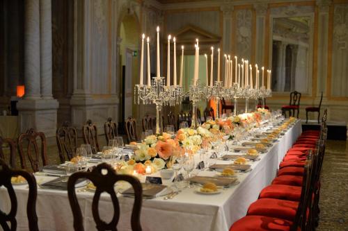 a long table with plates of food and candles at Monaco & Grand Canal in Venice