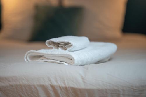 une pile de serviettes posée sur un lit dans l'établissement Appartement chaleureux le Grenier de Pommard, à Pommard