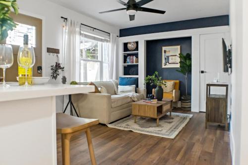 a living room with a couch and a table at Newly Renovated Gem Mins to Convention Center, Beaches and Downtown LB A in Long Beach