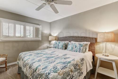a bedroom with a bed and a ceiling fan at 2 Bedroom/2 Bath, 3rd floor Oceanfront condo sleeps 6. Oceanfront deck and pool. in Fernandina Beach