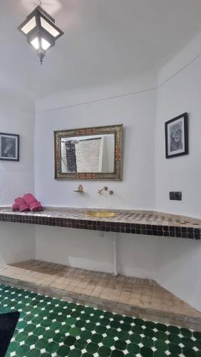 a bathroom with a sink and a mirror at Riad El Sagaya in Marrakech