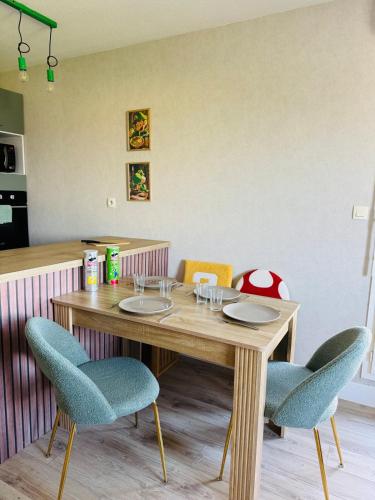 une table en bois avec deux chaises et une table avec des verres dans l'établissement Rétro Gaming Universe, Escape game & Gameroom, à Aucamville