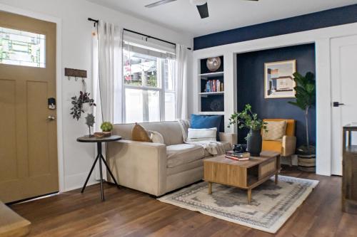 a living room with a couch and a table at Newly Renovated Gem Mins to Convention Center, Beaches and Downtown LB A in Long Beach