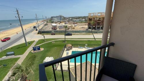 a balcony with a view of the beach and the ocean at Oceanfront Corner Unit with spectacular views in Ormond Beach