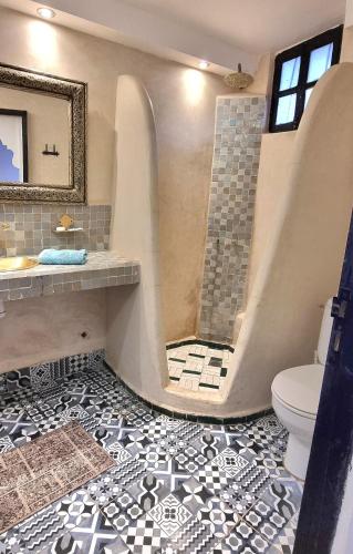 a bathroom with a shower and a toilet at Riad El Sagaya in Marrakech