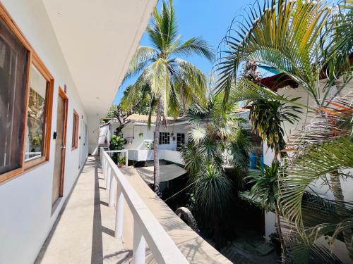 a balcony of a house with palm trees at Palmar la Punta 10 AC Starlink 2min walk to beach in Brisas de Zicatela