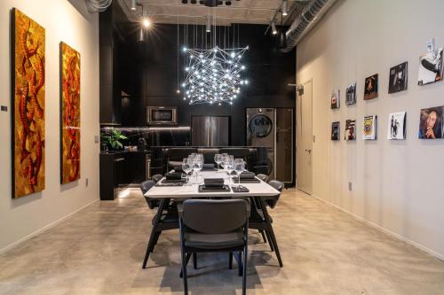 a dining room with a table and a chandelier at Wynwood Condo, Walk to Restaurants and Nightclubs! in Miami