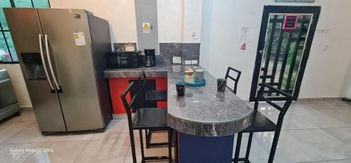 a kitchen with a counter with a table and a refrigerator at Evolution Home in Astoria