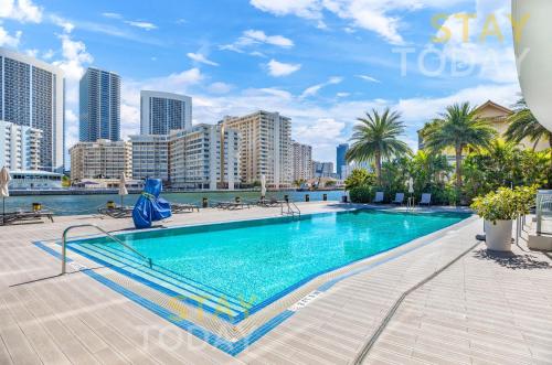 a swimming pool in the middle of a city at Resort-Style Living with Direct Ocean Views - 3BR Beauty in Hallandale Beach
