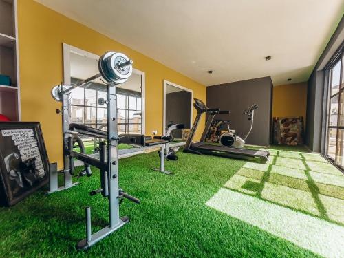 a gym with green grass and tread machines at PLATINIUM 2Bedroom with PS5 & Pool in Lagos