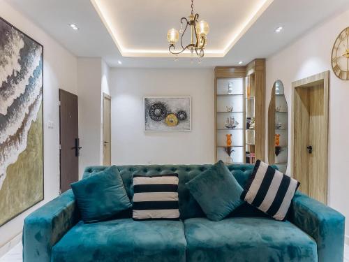 a living room with a blue couch at PLATINIUM 2Bedroom with PS5 & Pool in Lagos