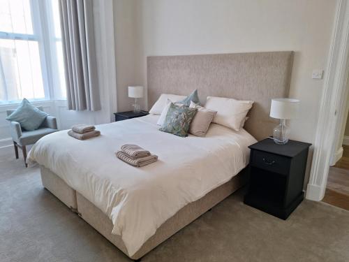 a bedroom with a bed with two towels on it at Annie's Place in Saltburn-by-the-Sea