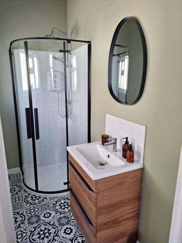 a bathroom with a sink and a shower with a mirror at Annie's Place in Saltburn-by-the-Sea