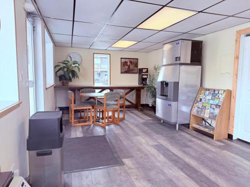 a room with a kitchen with a table and a refrigerator at Tomahawk Motor Lodge By OYO Riverton US-26 in Riverton